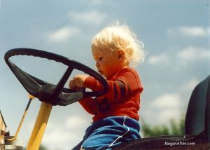 Baby Steve riding a tractor.